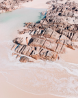 Aerial view of Injidup Beach, Yallingup with granite rocks surrounding a tidal pool with shallow clear water and coastal edges.