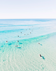 Aerial view of Second Bay, Coolum with a clear water break forming over shallow sand and visible seabed beneath