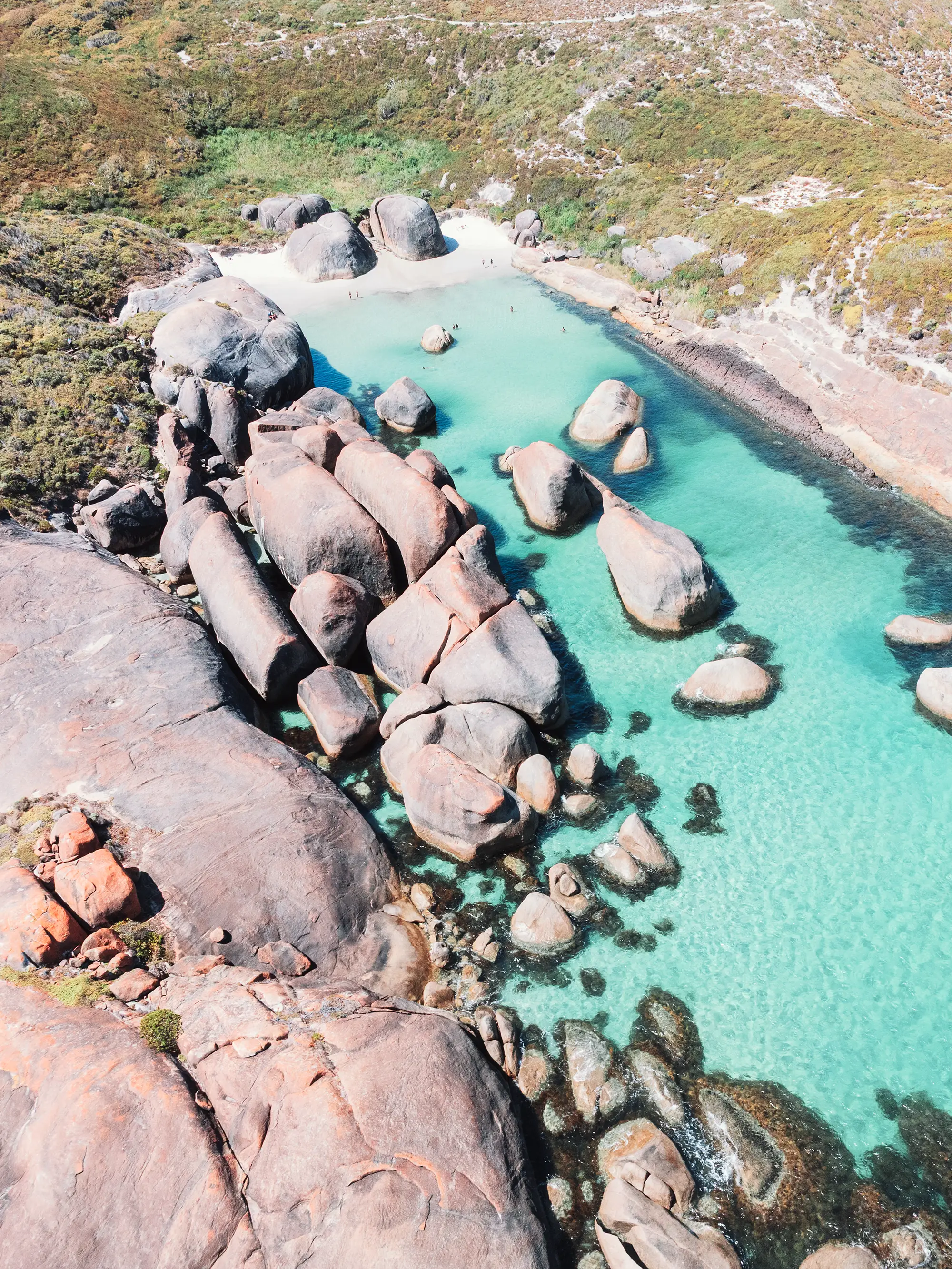 Greens Pool, Denmark showing granite boulders with clear shallow coastal water and pale sand along the shoreline