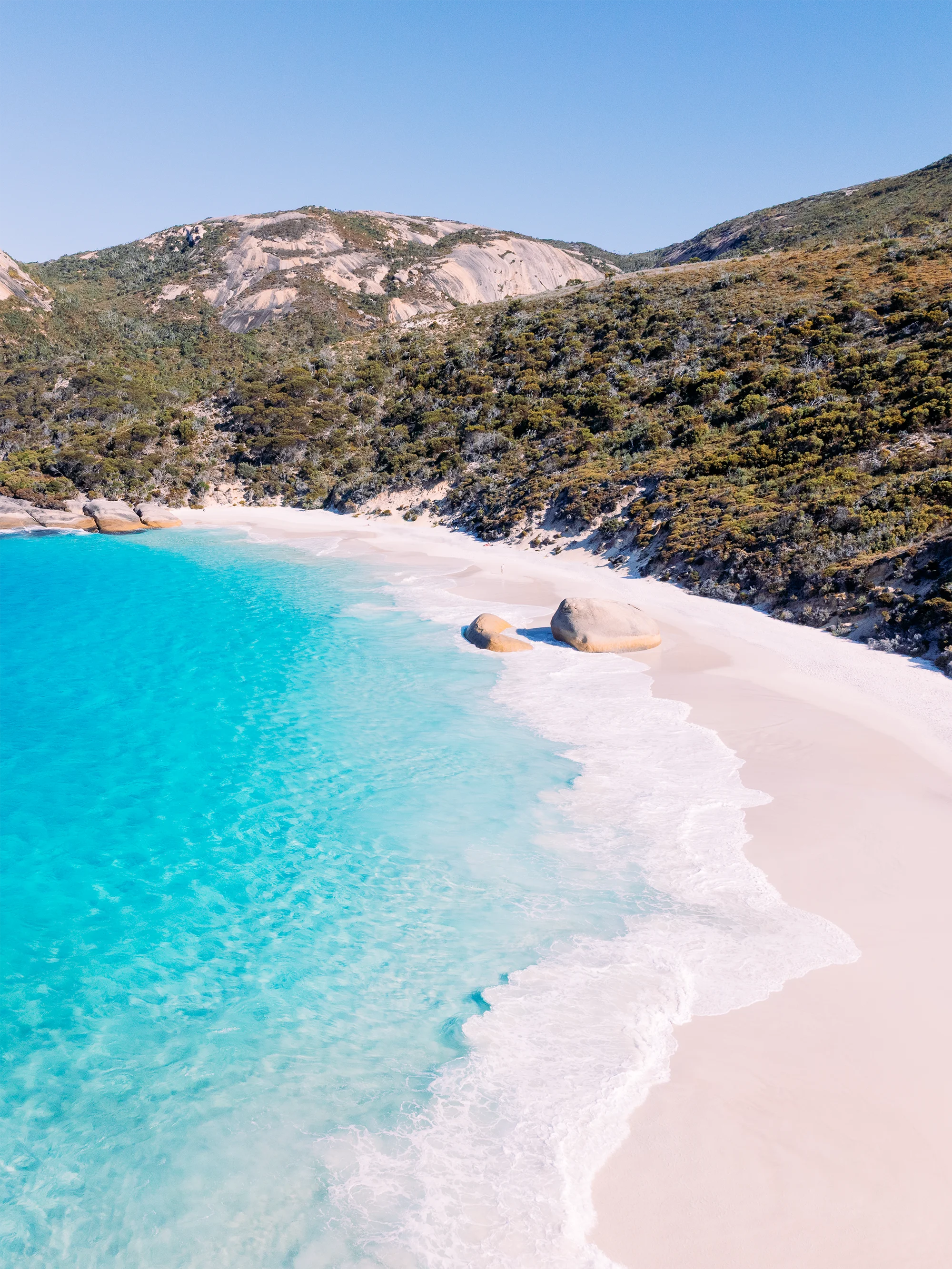 Aerial view of Little Beach, Albany with granite boulders on a curved beach and clear shallow water meeting pale sand