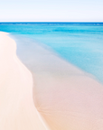 Sandy Bay, Cape Range showing pale sand shoreline meeting shallow clear water with a soft curved edge and minimal surface texture