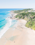 Second Bay, Coolum showing rocky headland forming a cove with sandy beach and shallow waves along shoreline