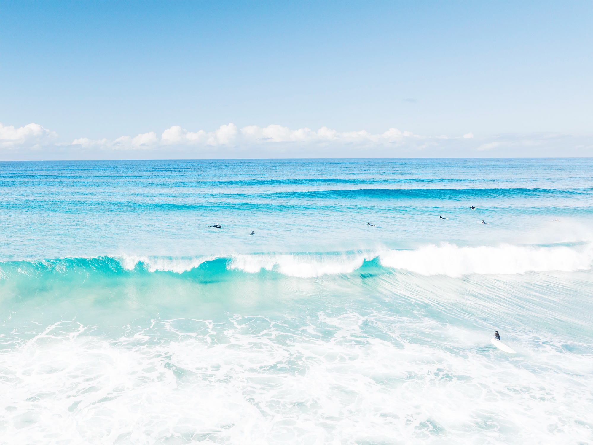 Blue skies over Suffolk Park Beach, Byron Bay with gentle waves and soft light captured in a fine art coastal print.