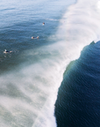 Surfers glide through ocean spray at Suffolk Park Beach, Byron Bay — a bright fine art coastal wall print.